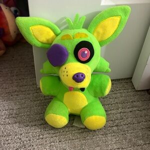 Vibrant Green and Yellow Stuffed Animal with Purple Accents